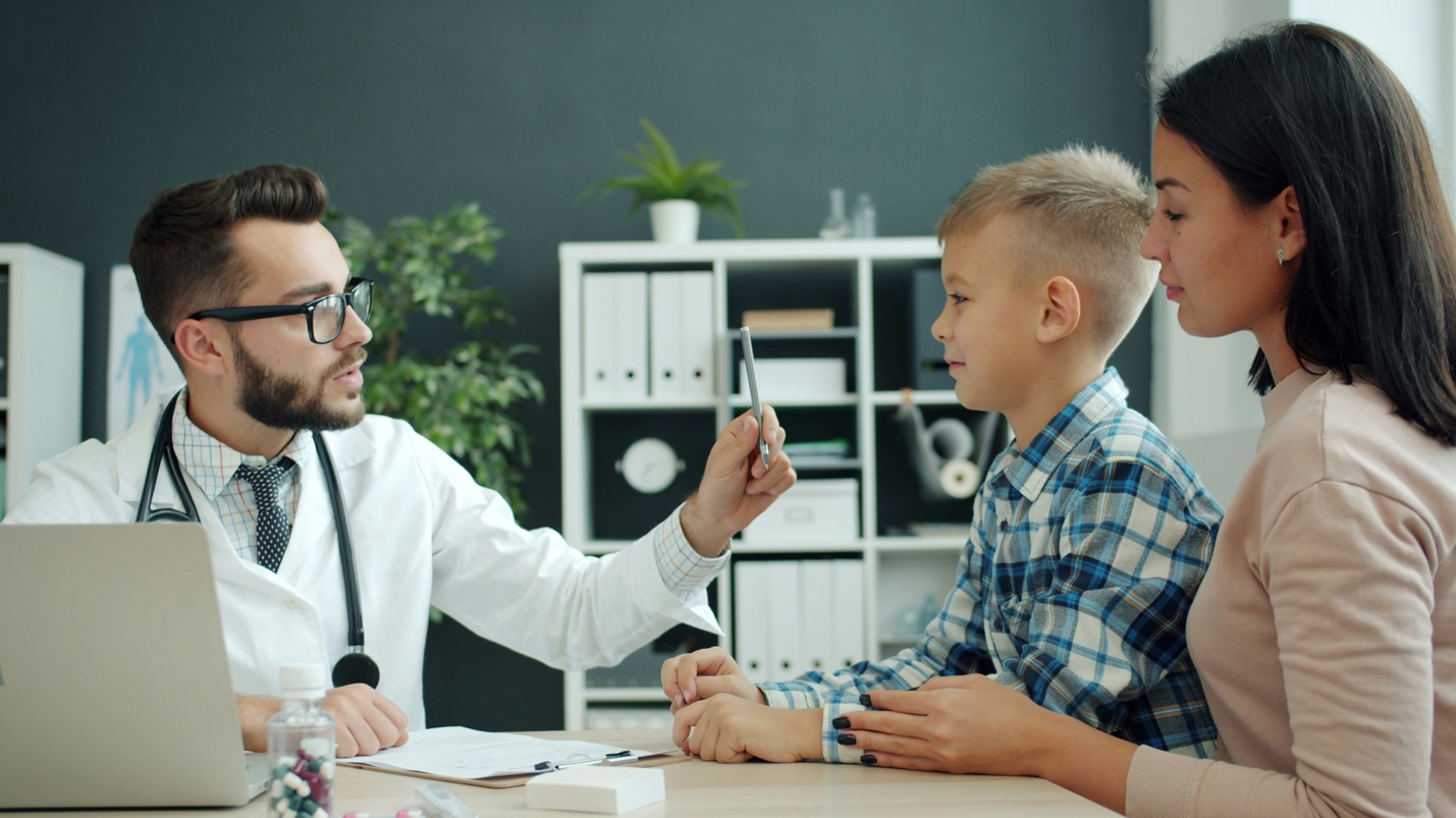 Doctor consulting with child and parent